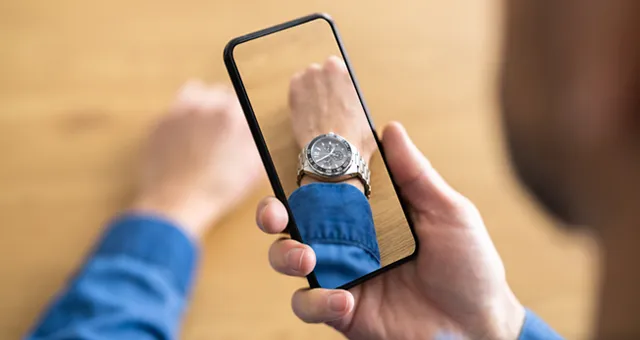 Man using iphone to try a watch on his wrist